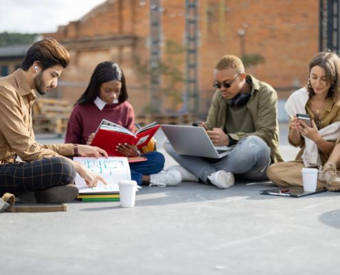 Students learn on asphalt at university campus